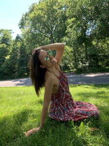 Girl with sunglasses sitting in park