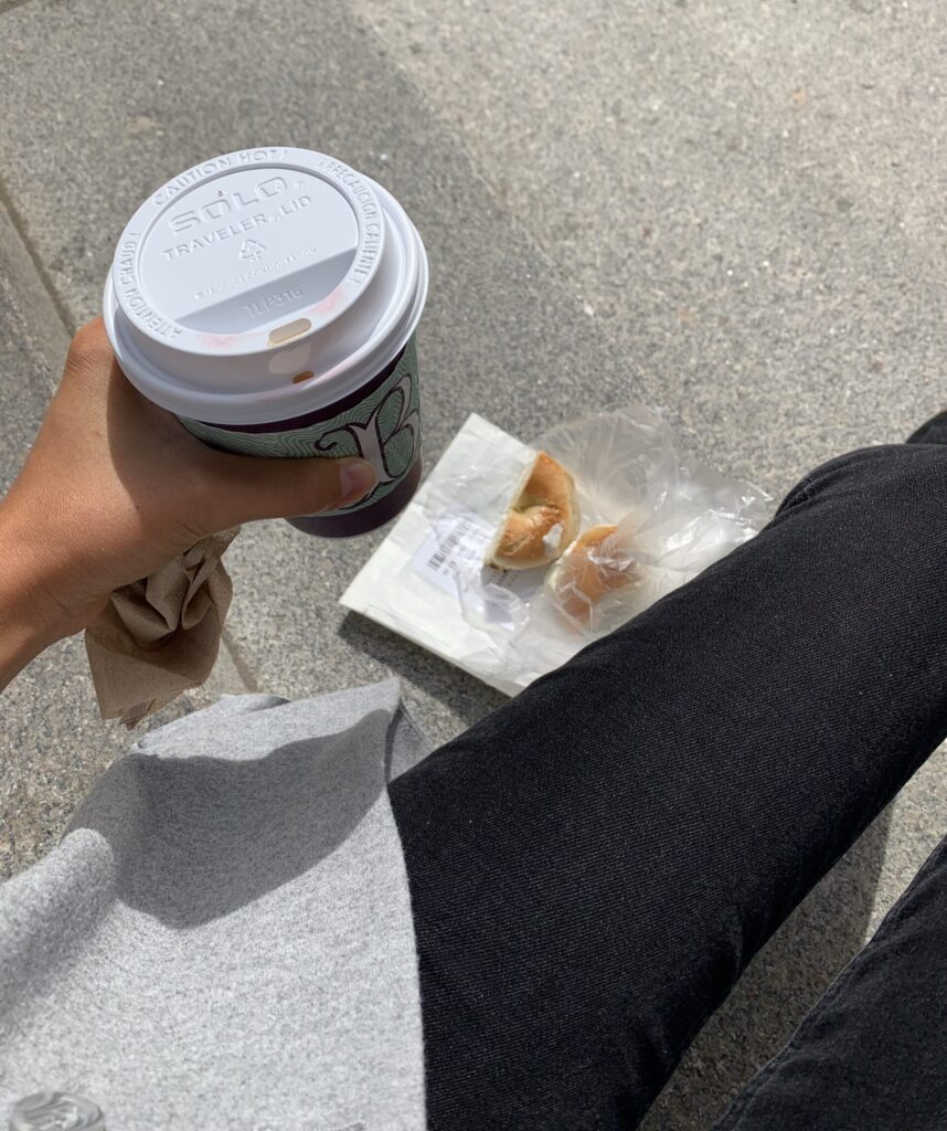 Holding coffee on steps of MET