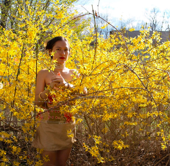 lady standing amongst yellow flowers