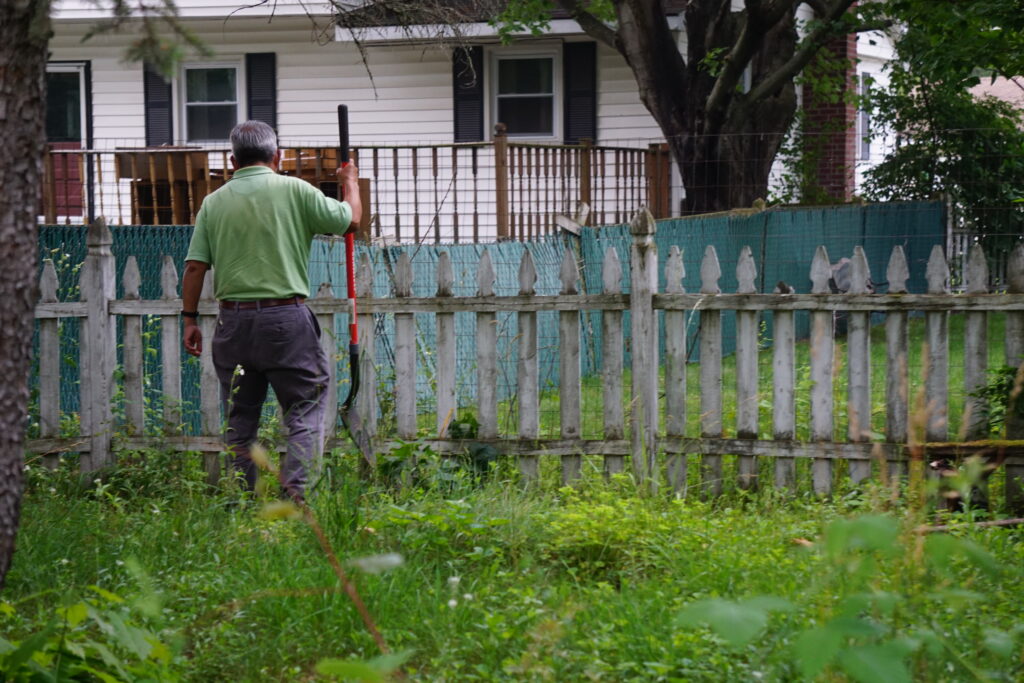 man with shovel in yard