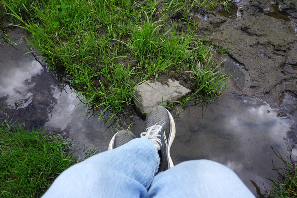 Feet hanging over bridge