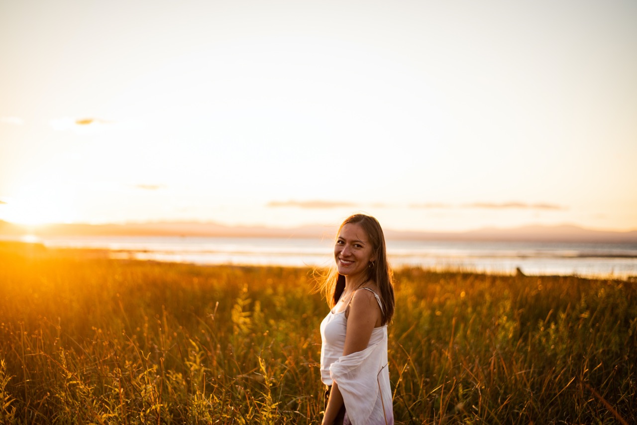 Girl in field at sunset