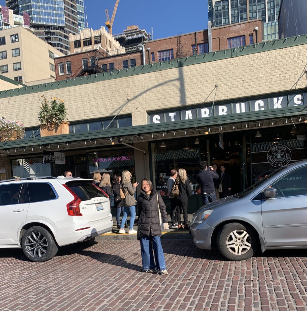 woman in front of original starbucks