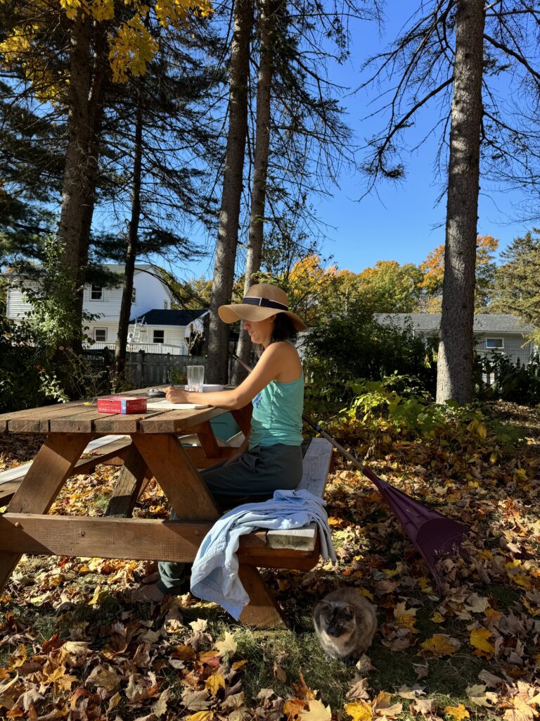 woman surrounded by fall leaves