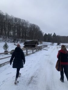 two people walking by a farm in winter