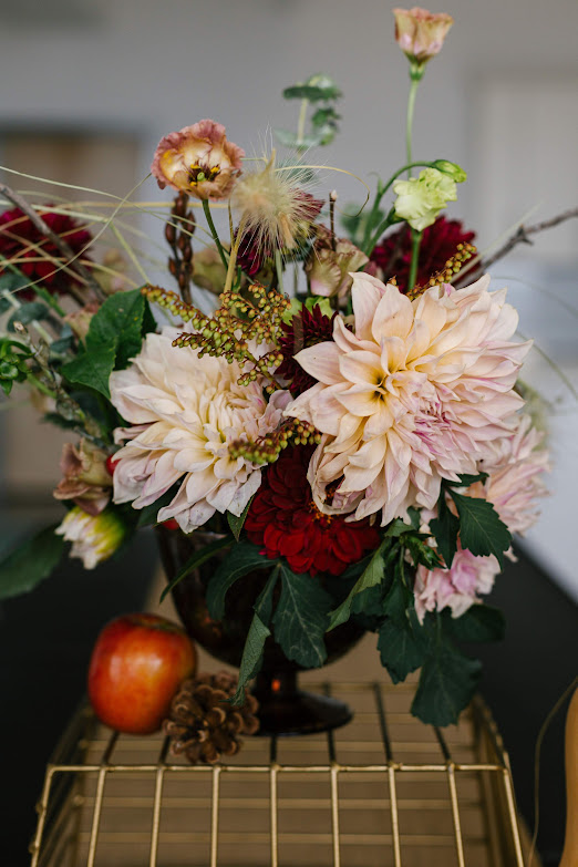 Pink and red flowers in compote vase