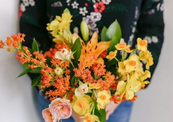 orange and yellow flowers in vase