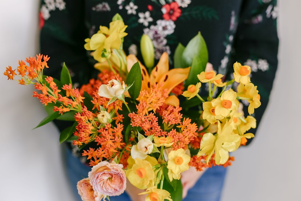 orange and yellow flowers in vase