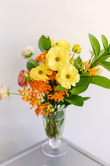 small vase with yellow and orange flowers