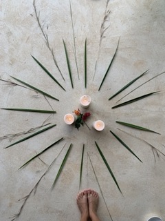 three candles with grass in circular design