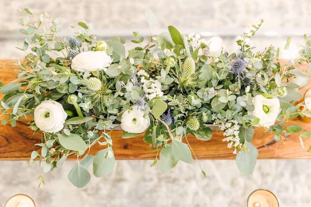 greenery and white ranunculi centerpiece