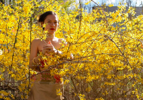 lady standing amongst yellow flowers