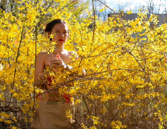 lady standing amongst yellow flowers