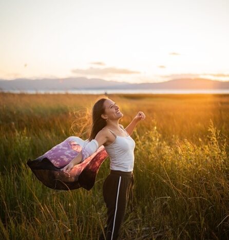 Women in field at golden hour