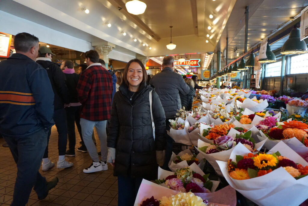 Woman next to flowers in Pike Place