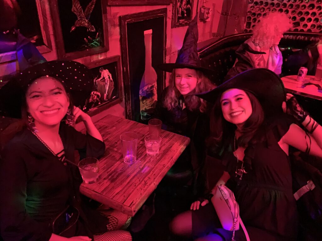 three witches in room with red light