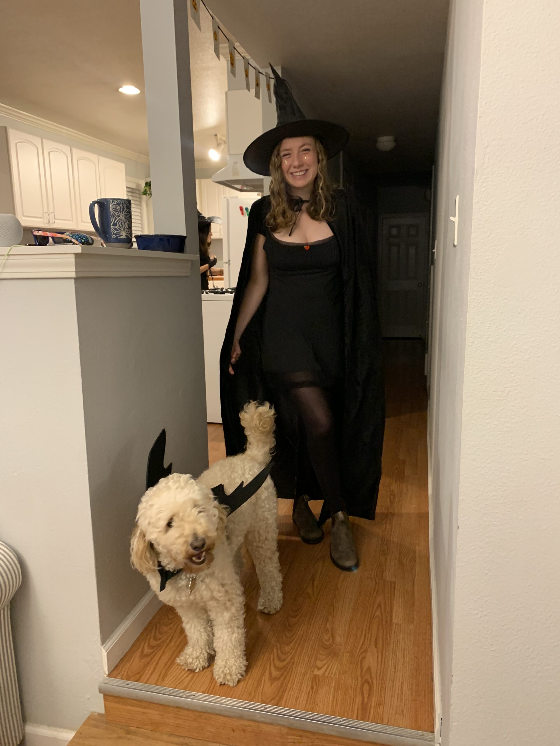 woman with witch costume and dog