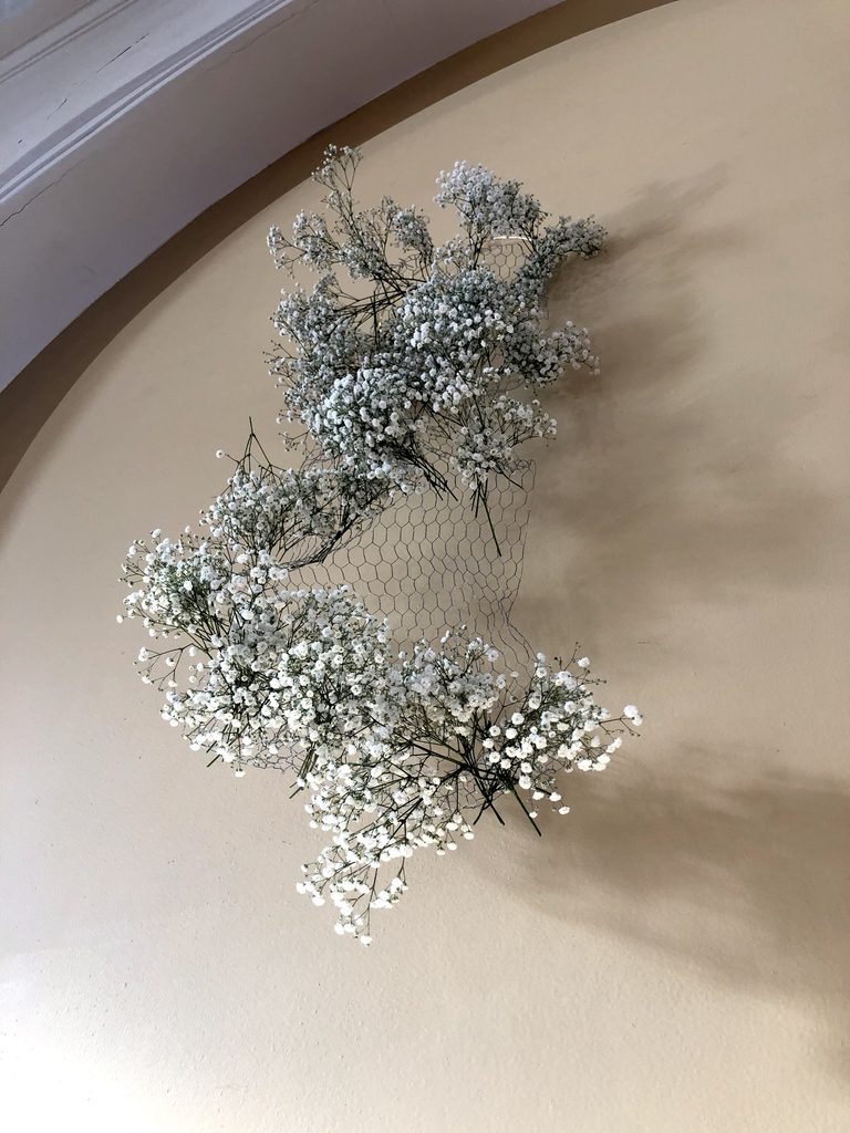 Floral art hanging wire with baby's breath cascading down for waterfall effect.